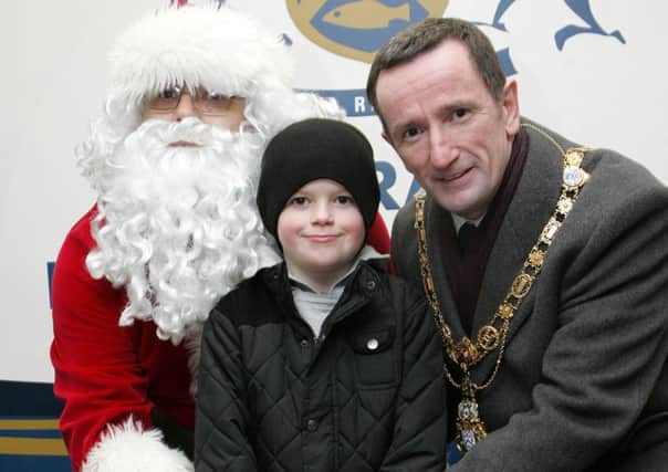 Dillon Elder Garvagh Primary School pupil and competition winner switches on the Christmas lights in Garvagh with the help of Santa, and the Mayor of Coleraine, Councillor George Duddy. INCR51-327PL