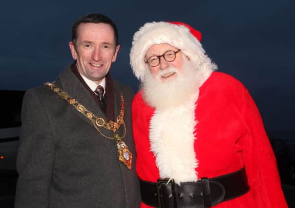Councillor George Duddy, Mayor of Coleraine, and Santa pictured at the switch on of the Christmas lights in Portballintrae on Saturday. INCR51-370PL