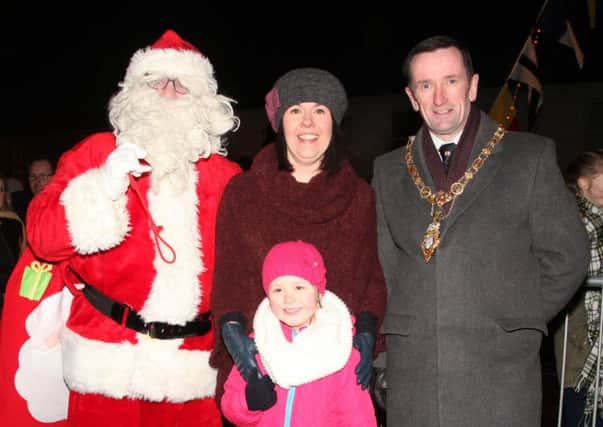 Santa and Councillor George Duddy, Mayor of Coleraine, pictured with Jolene Calvin and her daughter Amy who won the Mayor's colouring competition to switch on the Christmas lights in Castlerock  last Thursday. INCR51-342PL