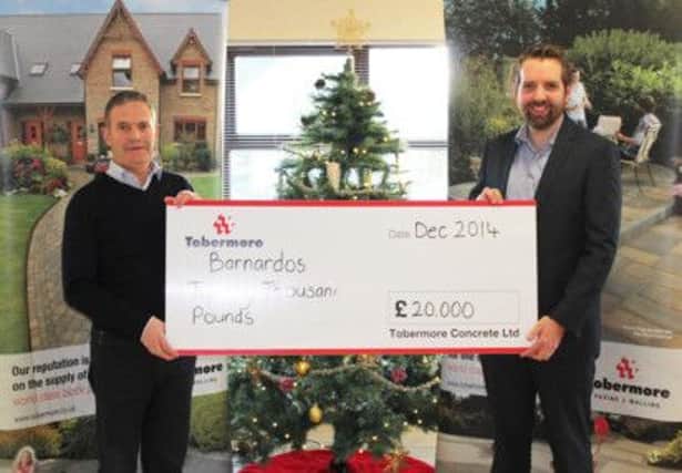 Roger Gowdy, Community Fundraising Volunteer Manager for Barnardo's Northern Ireland  pictured being presented with the fantastic donation for £20,000  from Tobemores Managing Director, David Henderson.