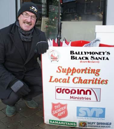 DON'T LIAM ALONE. Pictured doing his annual Christmas 'Sit Out' for local charities, is Ballymoney's own 'Black Santa' Liam Beckett.INBM52-14 040SC.