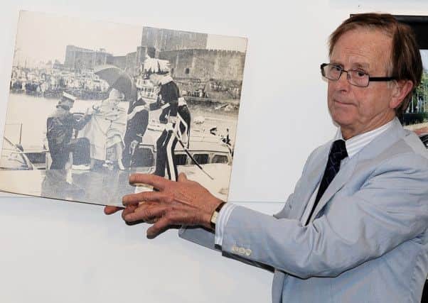 Carrickfergus Photographic Society guest speaker Stanley Matchett with his image of Queen Elizabeth II during her 1960s visit to the borough. INCT 46-706-CON