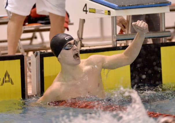 Larne's Conor Ferguson from Larne celebrates as he breaks the Irish junior record for the 200m backstroke. Photo: Presseye