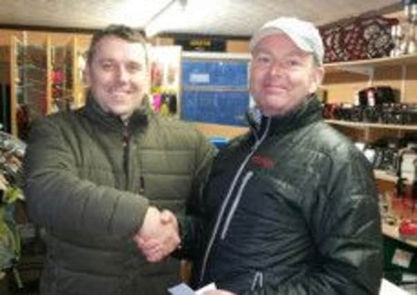 Kenny Ferguson, runner-up in round three in angling's Woodford Winter League is congratulated by Darren Wallace. INLT 52-903-CON