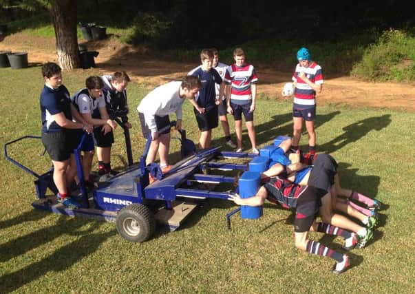 Carrick Grammar's forwards get to grips with the scrum machine duirng their training camp in Portugal.