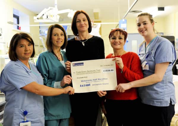 Emergency Department Staff at Altnagelvin Hospital presented a cheque of £1,028 to Suzy Ward. 
Suzy is accepting the donation on behalf of the Foyle Down Syndrome Trust. 
The Emergency Department staff raised the money by taking part in the Waterside Half Marathon in September. Pictured Left to Right is Geraldine Brown; Anne McCleod; Suzy Ward; Claire Crossan and Laura Dalzell. Absent from the picture is Anita Boyle.
