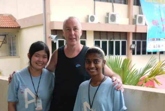 Banbridge artist Tommy Barr pictured with his two studio assistants Yule and Ramyah at the Sasaran International Arts Festival, Malaysia