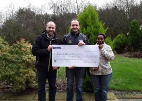 Pictured presenting the cheque on behalf of YFCU is Martyn Blair, YFCU president, with Richard Spratt (l), CEO Fields of Life Northern Ireland and Cathy Kaitesa, Fields of Life Uganda Office.  INCT 53-722-CON