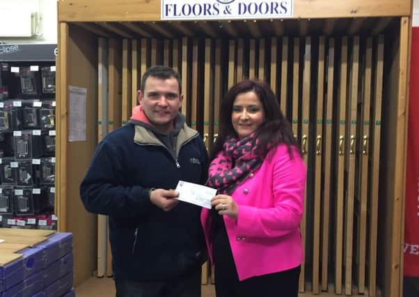Charis recieves £250 donation from Murdock Builders' Merchants