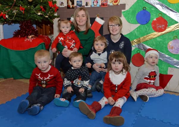 Ladybird Day Care Nursery staff members, Lisa Charters and Lauren Robb with children with their Christmas jumpers on to raise funds for Save the Children. INLT 51-015-PSB