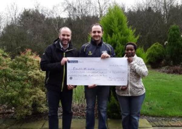 Pictured presenting the cheque on behalf of YFCU is Martyn Blair, YFCU President, with Richard Spratt (l), CEO Fields of Life Northern Ireland and Cathy Kaitesa, Fields of Life Uganda Office.