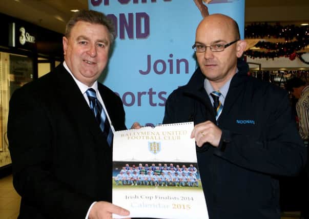 Brian Thompson of Ballymena United is pictured presenting  a copy of the new Ballymena United 2015 to David Morrison of the Tower Centre. INBT53-210AC