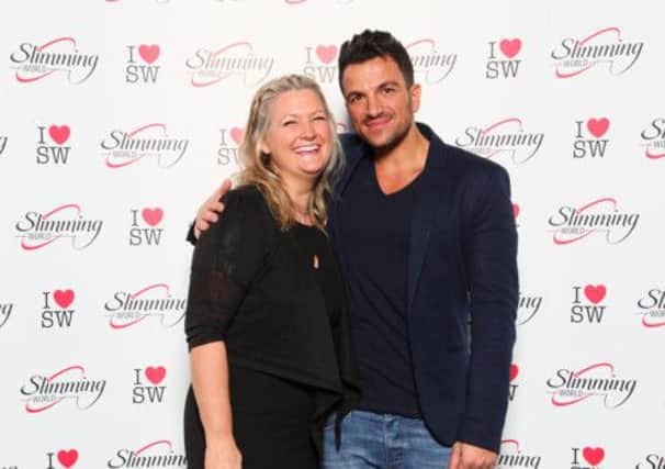 Slimming World manager Clare McDaid cuddles up to singer and TV presenter Peter Andre.