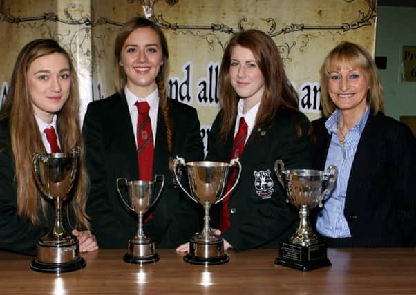 Cambridge House students Lydia Crawford, Megan Graham and Emma Herron, who were the top achievers in GCSE, are pictured with principal Mrs. E. Lutton. INBT52-209AC