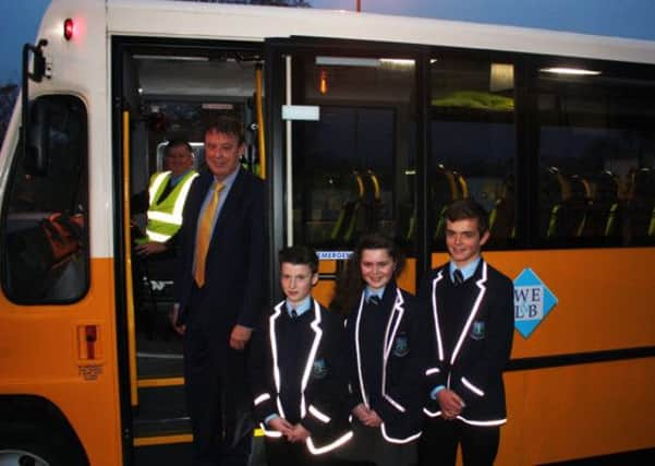 WELB Chief Executive Barry Mulholland promotes the WELB's annual Stay Safe message to pupils, who are pictured alongside a WELB school bus fitted with high visibility seatbelts, showcasing their school blazers and scarves embellished with reflective strips which makes them highly visible as they travel to and from schools and colleges during the dark winter mornings and evenings.