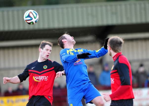Moyola win this high ball during Saturday's 1-1 draw with local rivals Tobermore Utd at FortwilliamPark.INMM5214-433