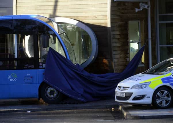 The scene of the tragic incident at Lisburn bus depot is covered by a sheet on Monday as police investigated