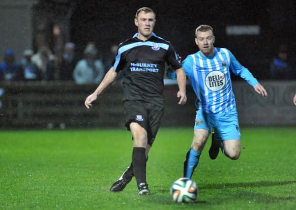 Ballymena United defender Johnny Taylor clears the ball from Warrenpoint Town's Timmy Grant during today's match at Milltown. Picture: Press Eye.