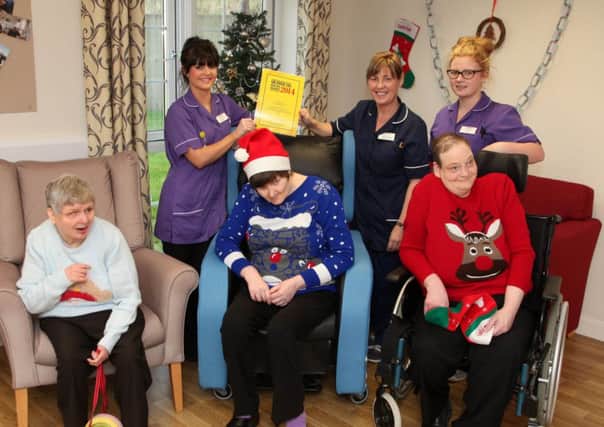 Bohill staff members Shannon Laverty, Hazel Schwarz, and Kylie McNeill along with residents pictured with the Most Outstanding Residential Care Service in the UK 2014 award. INCR52-327PL