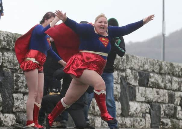 Angela McClemments was the star turn as always at the Spina Bifida Hydrocephalus New Year's Day charity swim at Carnlough Harbour. This year she and her daughter Megan wore Superman costumes. INBT 02-110JC