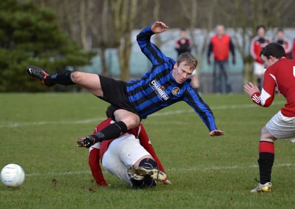 BBOB's Liam Doherty feels the weight of this challenge from Foyle Wanderers player David Scanlon. INLS0115-103KM