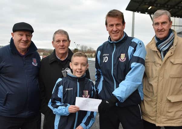 Sam Stewart presents the Seven Towers Supporters' Club's December Player of the Month award to Allan Jenkins. Looking on are Allen Stewart, Uel Allen and Tommy Patterson.