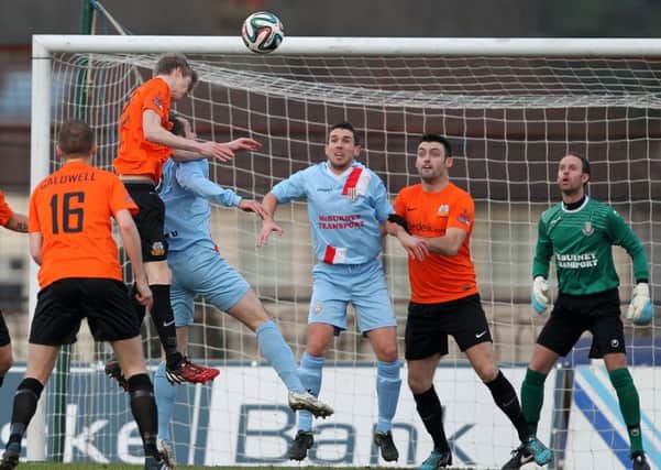 Rhys Marshall header ends up dropping on top of the bar at Ballymena. Pic by Presseye