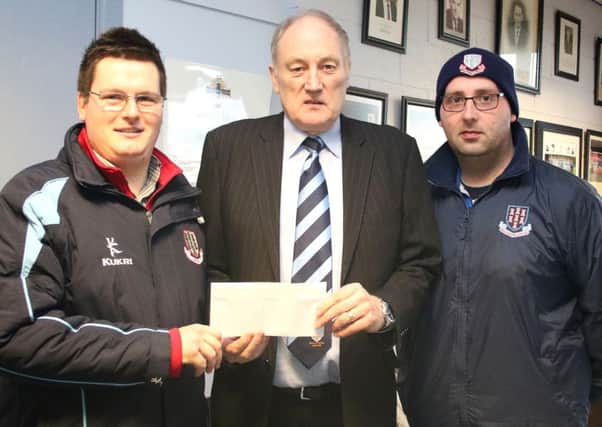 '12th Man' committee members Philip Simpson and Darren Archer present a sponsorship cheque for Saturday's game to United chairman John Taggart. Picture: Damian McKee.
