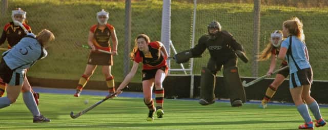 UNDER PRESSURE. Ballymoney 2nds player, Ruth Sutherland  (No.5) fires in a shot as her team puts the Lurgan defence under pressure during their game on Saturday.INBM1-15 020SC.