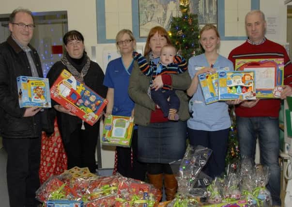 Mr Gordon Fegan and his wife Amanda, present Tracy Gemmell, Ward Sister and Sarah Strain, Staff Nurse, Barbour Ward, Royal Belfast Hospital for Sick Children with practical items and toys purchased with the proceeds totalling £1,748.47 pence, raised during a Gospel Concert, held in Rathfriland High School on Friday 24th October 2014. Also included are left, Pastor Ian Wilson, Rathfriland Baptist Church, and centre, Julie Ozlu and her son Noah, a former patient of the Barbour Ward.  © Photo: Gary Gardiner. IN BL WK 0115-502.