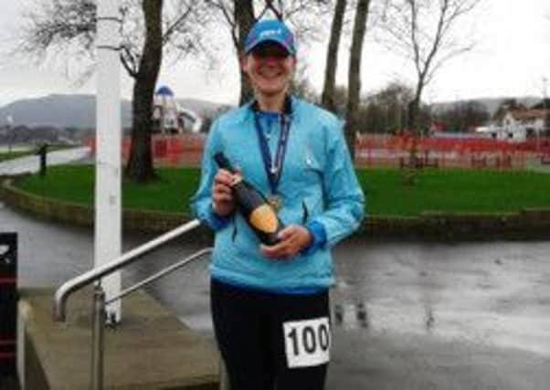 Seapark AC's Gillian Cordner celebrates completing 100 marathons.