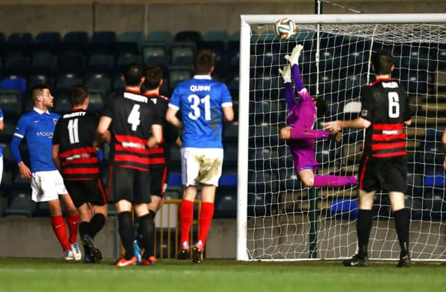 Linfield's Ross Glendenning can't stop Neil McCafferty from scoring his superb last-gasp free kick during Saturday's Danske Bank Premiership game at Windsor Park. William Cherry/Presseye