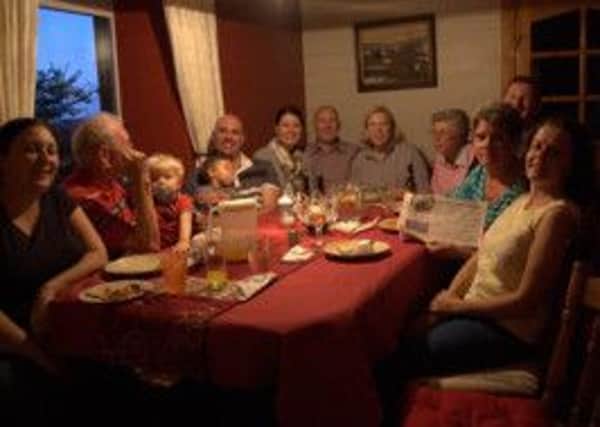 Pat Welsh (right, holding the Times) with extended family members during her visit to Northern Ireland.  INCT 02-720-CON