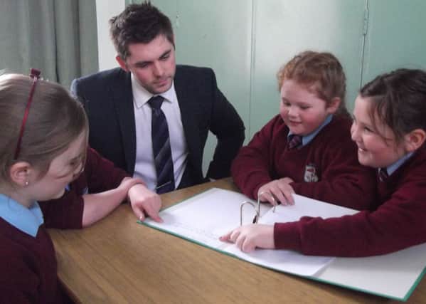 Principal of Upper Ballyboley Primary School, Paul Smith provides guidance to school council memners Ellan Spence, Stacey McAuly and Katie Stewart.  INLT 03-675-CON
