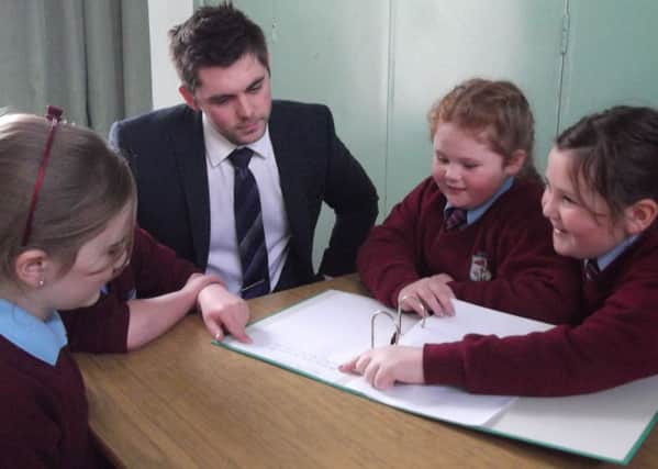 Principal of Upper Ballyboley Primary School, Paul Smith provides guidance to school council memners Ellan Spence, Stacey McAuly and Katie Stewart. INLT 03-675-CON