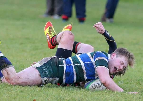 Grosvenor's Thomas Quinn pushes forward to score a try