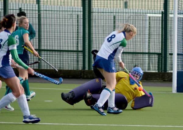 Carrick Ladies keeper Karen Nelson pulls of a fine save to keep out Ballymenaâ¬"s Amy Logan. INCT03-134-GR