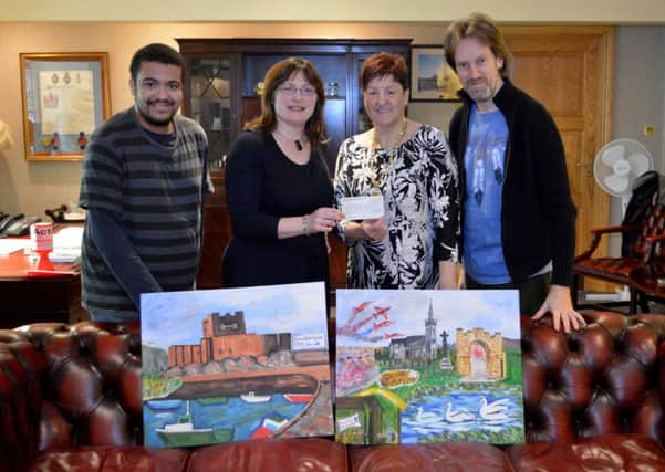 Mayoress of Carrick Patricia Johnston receives a cheque from TRIART artists Michael Saprkes, Joanne Campbell and Steve Diamond.  £129 was raised in aid of the Carrickfergus Action Cancer group. INCT 04-115-GR