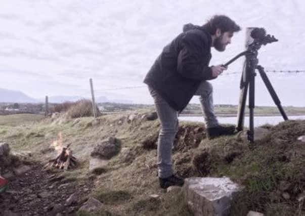 Artist Sean Mullan working on a film in Donegal.