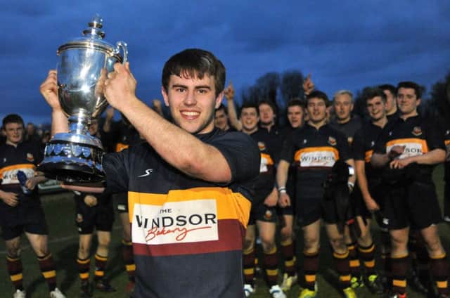 Banbridge captain Ryan Dennison (c) proudly lifts the Nutty Krust trophy in 2013 after a final win over Portadown. Pic: Tony Hendron Digital Photography