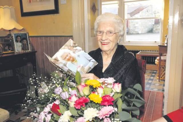 Mrs Elizabeth Thompson who celebrated her 100th birthday at Spice Cottages, Moy Road Dungannon reads a special message from HM Queen Elizabeth 11 in recognition of her special birthday.dd0307