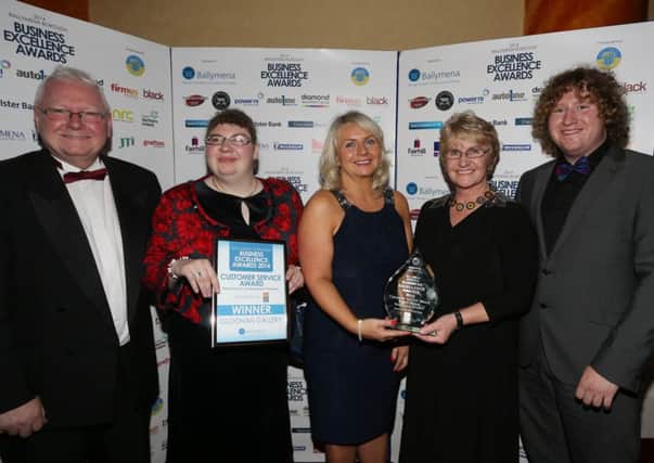 Patricia Perry of Gloonan Gallery pictured at the Ballymena Chamber of Commerce & Industry annual Business Excellence Awards 2014 receiving the Customers Service Retail Sector (Independent Retailer) award from Jayne Mahon of category sponsors First Trust while looking on are James, Sarah and Christopher Perry.