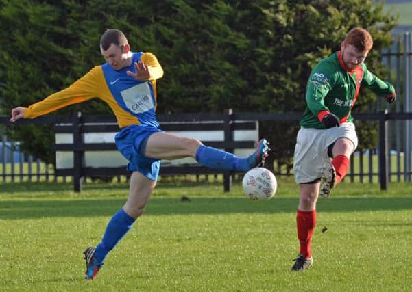 Nortel's Jackie Moore battles for possesion in the Clarence Cup defeat to Larne Tech Old Boys. INLT 04-016-PSB