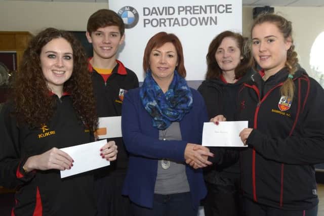 Heather Marriott (left), Sam Farson and Megan McKenna (right) are presented with their Player of the Month awards by David Prentice Marketing Manager Judi McClelland. Included is Banbridge President Sheree Totton. INBL1503-246EB