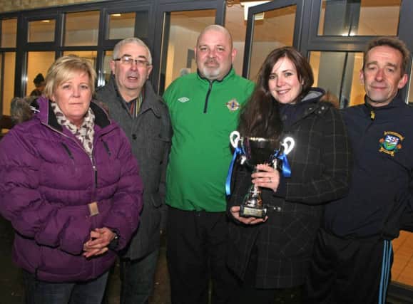 TOGETHER. Christopher's wife Gillian, pictured with the Memorial Cup along with his parents, PJ and Diana, Father-in-Law Carson Shaw and one of the organisers, Mervyn McIntyre on Wednesday night.INBM49-14 014SC.