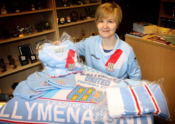 Dawn Galloway of Stirling Trophies with some of the Ballymena United merchandise on sale at the Queen Street premises, ahead of Saturday's WASP Solutions League Cup final against Cliftonville. INBT04-224AC
