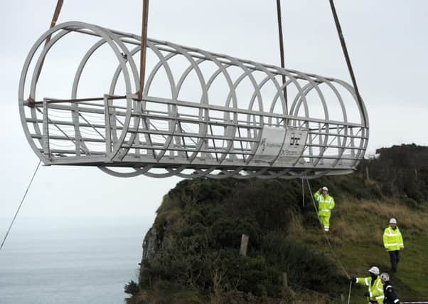 (file photo) The tubular bridge section of the Gobbins cliff path is lowered into place.  INLT 44-676-CON