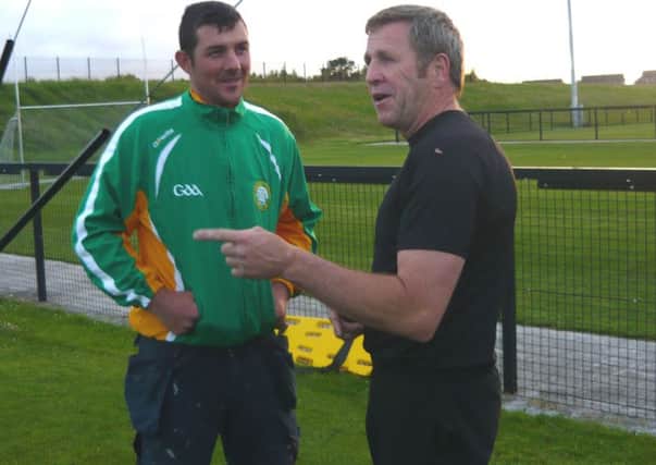 Shane McConville talks tactics with player Michael Shanks.