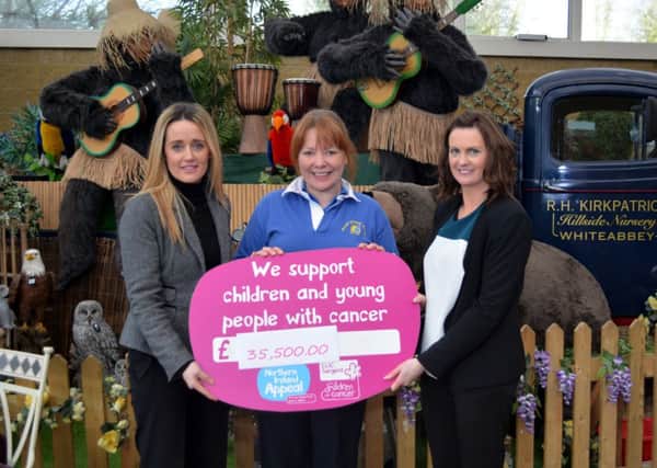 Fiona McCann and Nadine Campbell from Clic Sargent and Karen Palmer from Hillside Nursery announce the grand total raised for the charity from the Christmas Grotto. INNT 04-132-GR