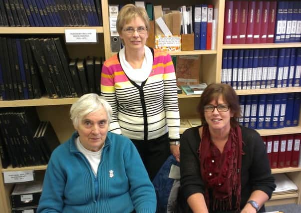 Sandra Ardis, NIFHS education and development officer, with society members Edith Tuckey (left) and Yvonne Griffiths (right) at the library and research centre in Newtownabbey.